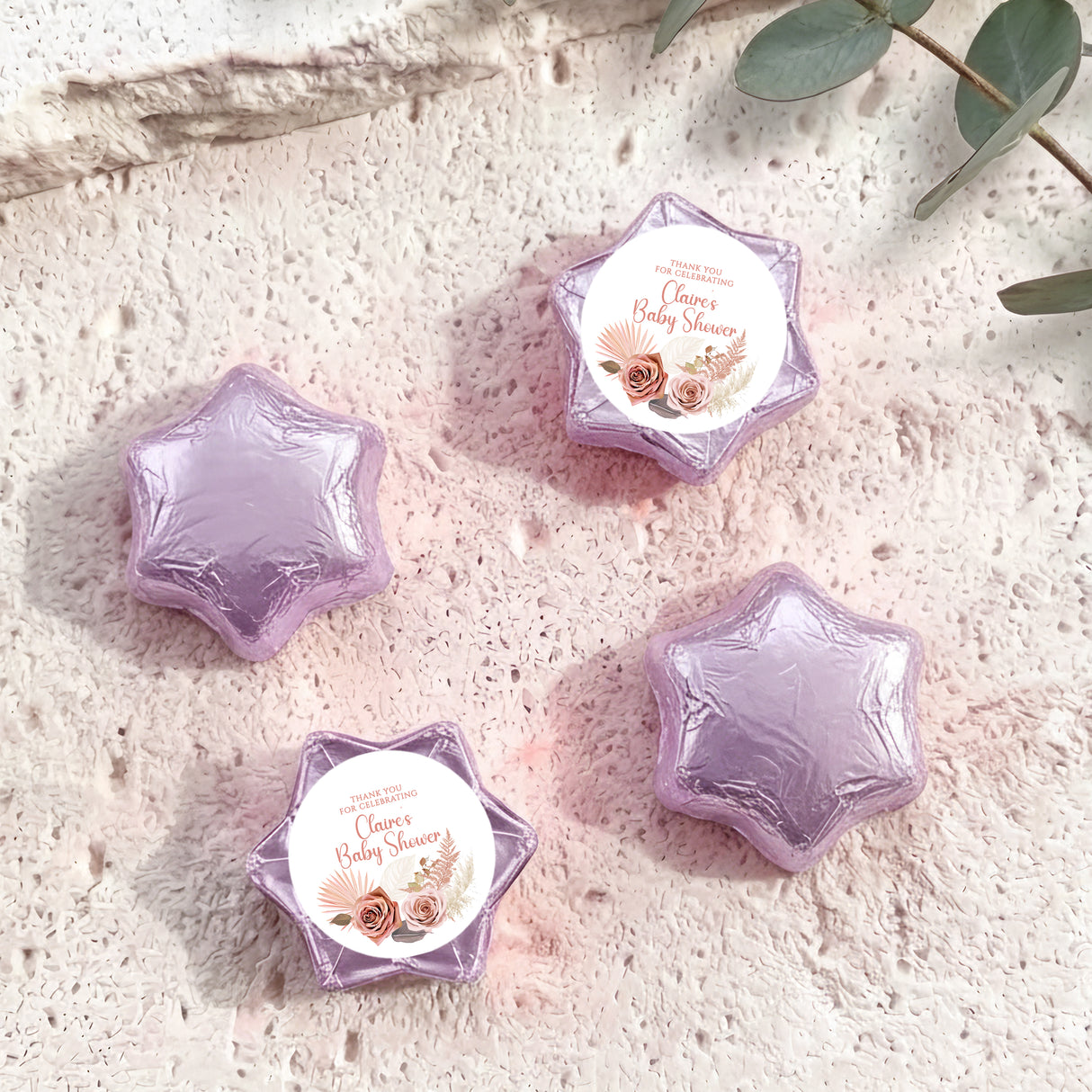 Purple/lavender foil-covered chocolate stars with round 'Baby Shower' label