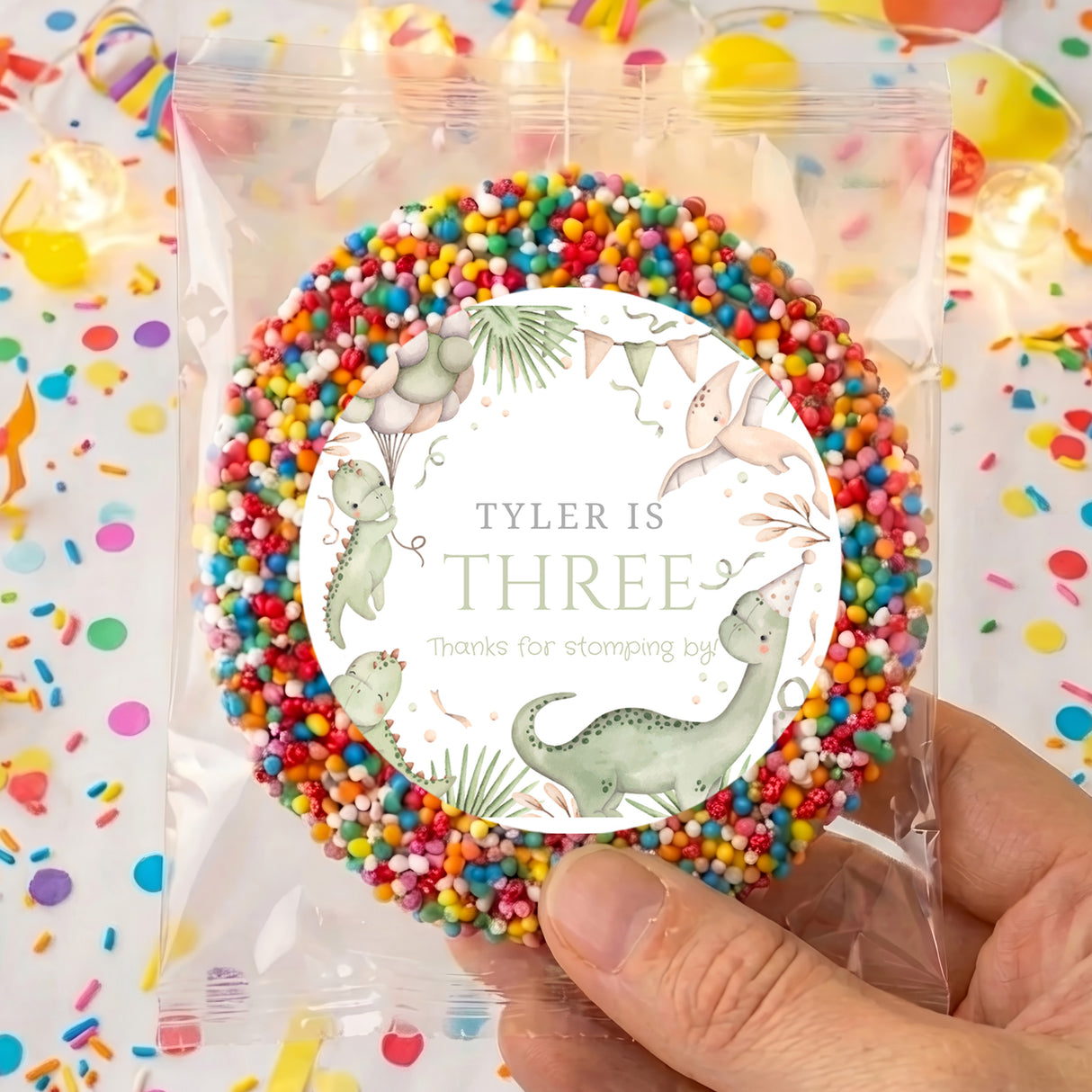 Personalised dinosaur birthday cookie: Tyler is three, round with colorful sprinkles
