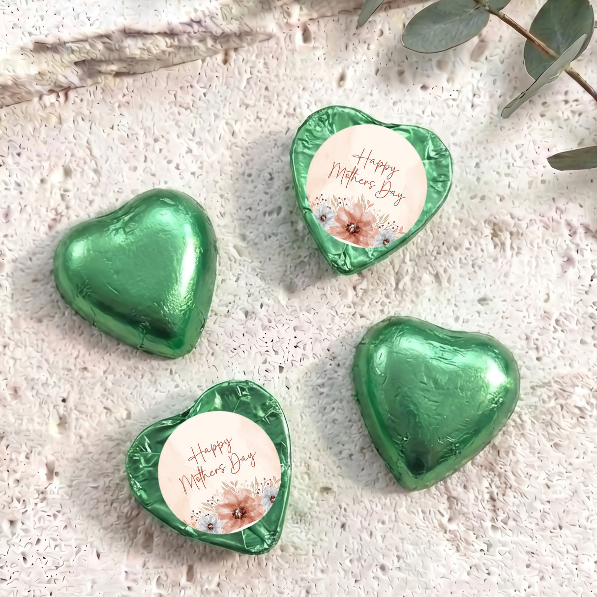Green heart-shaped foil chocolate with “Happy Mother’s Day” floral message on white center