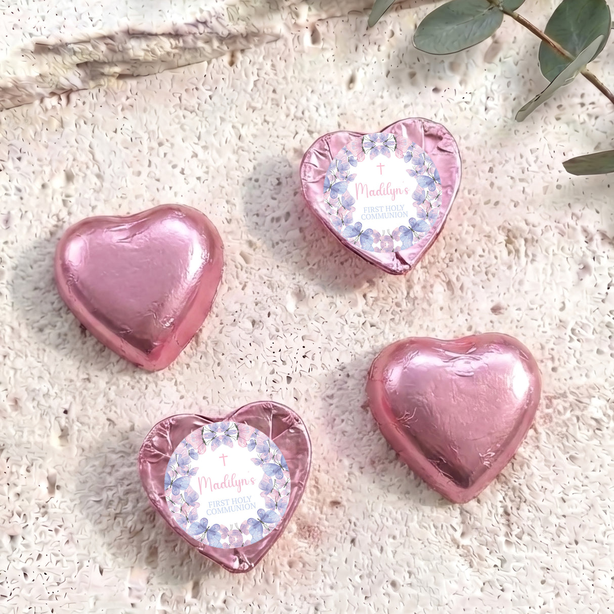 Pink foil-covered chocolate hearts with floral design and personalized message