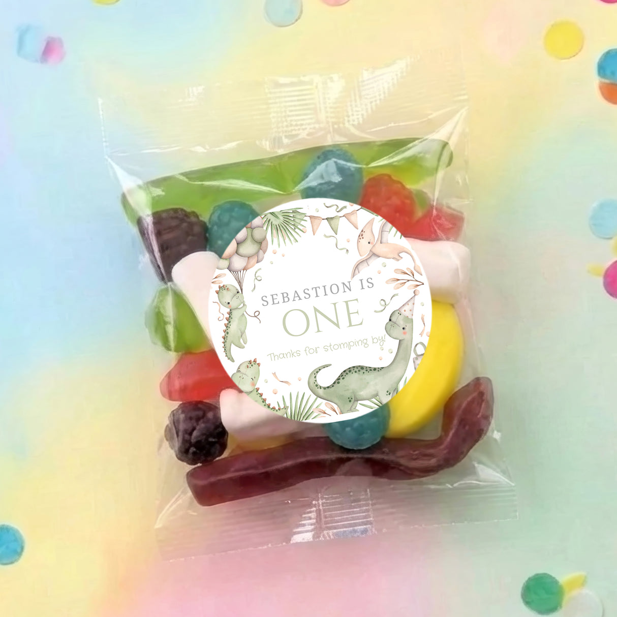 Pastel dinosaur lolly bag with 'Sebastian is One' circular label