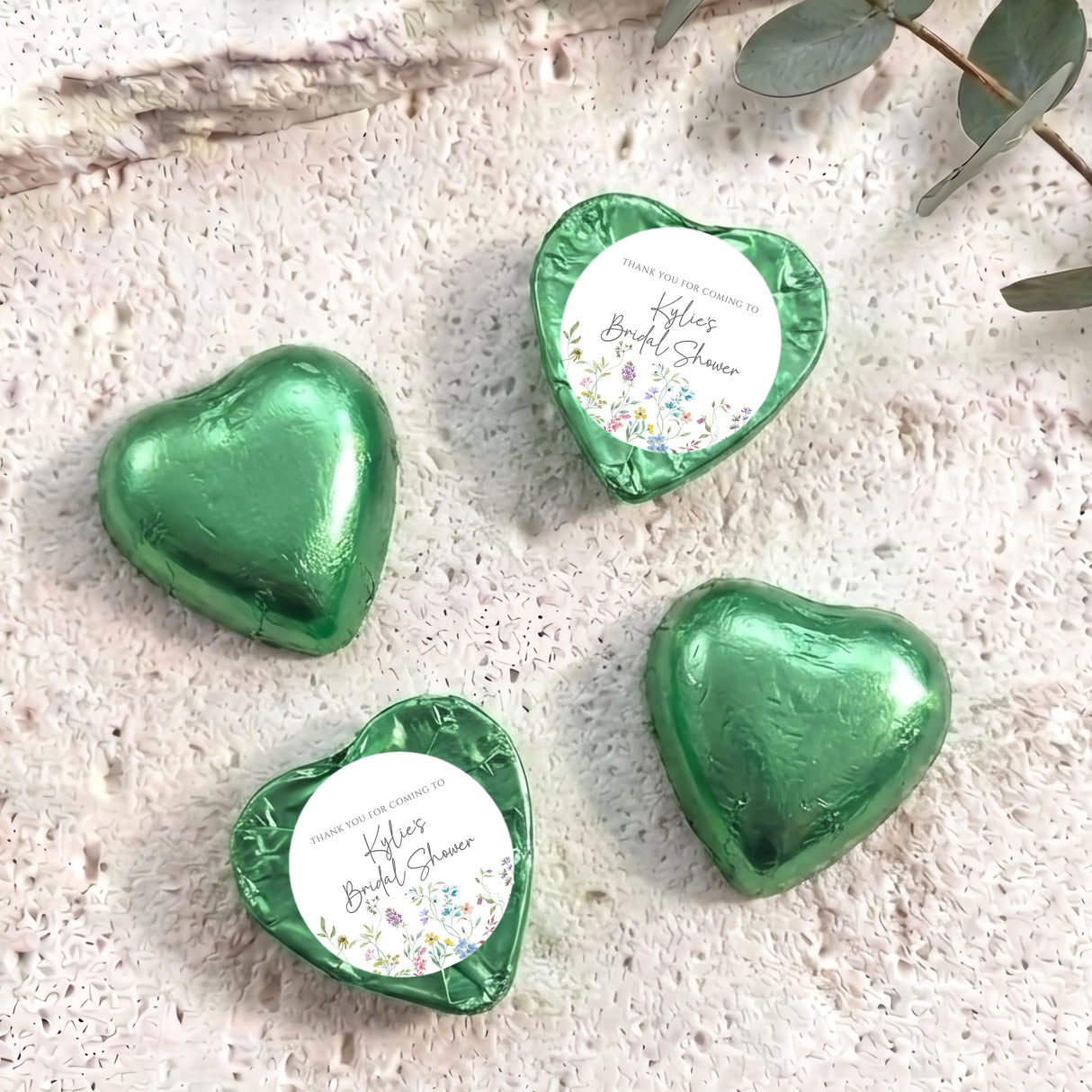 Green foil-covered heart chocolates with thank-you bridal shower label
