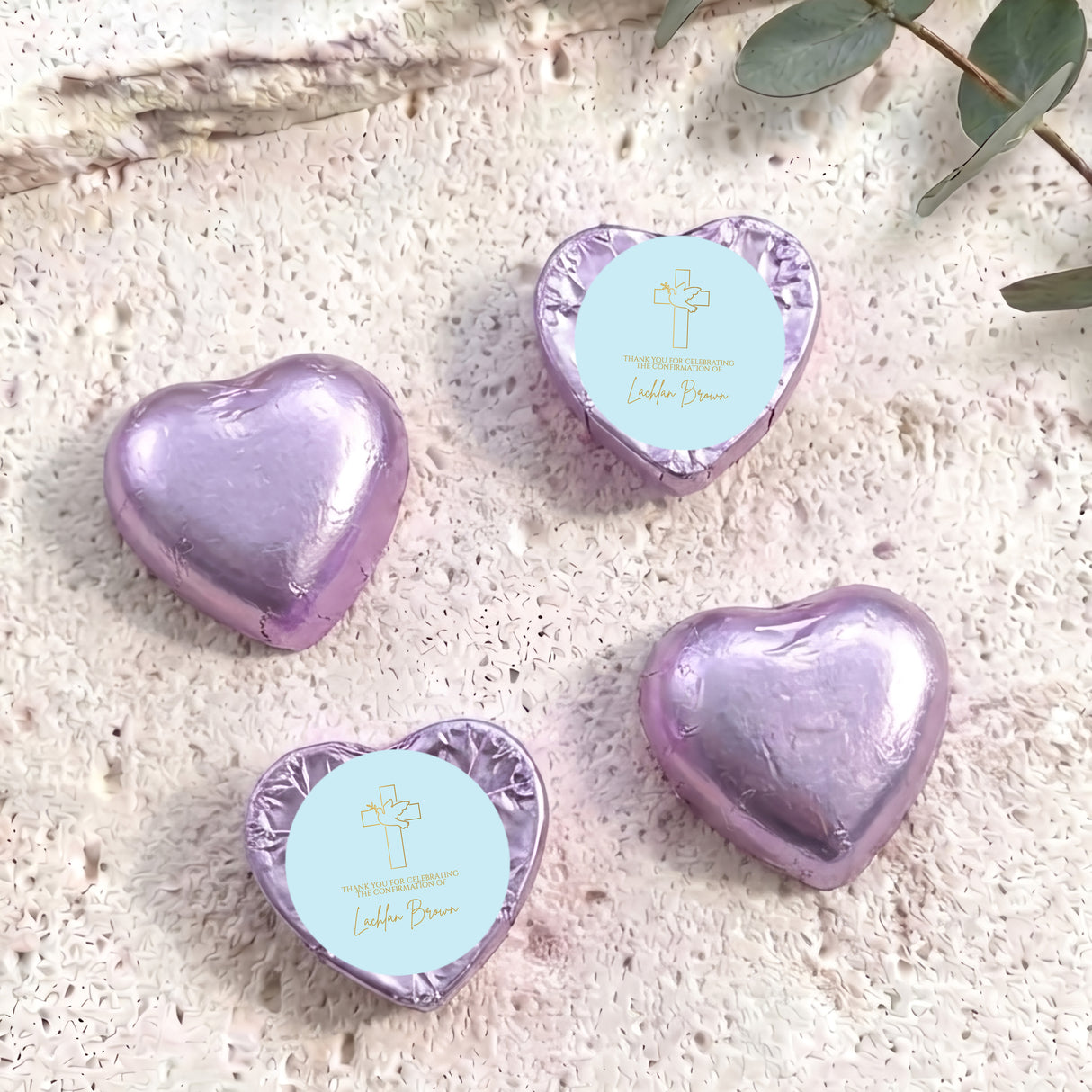 Foil-covered chocolate heart sweets in lavender, with cross and name text.