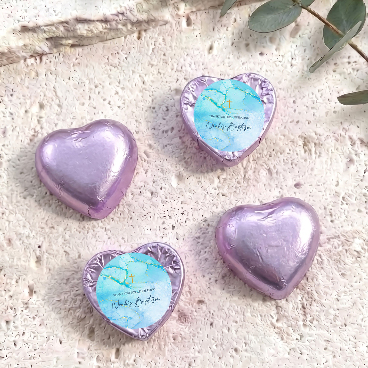 Purple foil heart chocolates for baptism, with blue label, gold cross and handwritten name