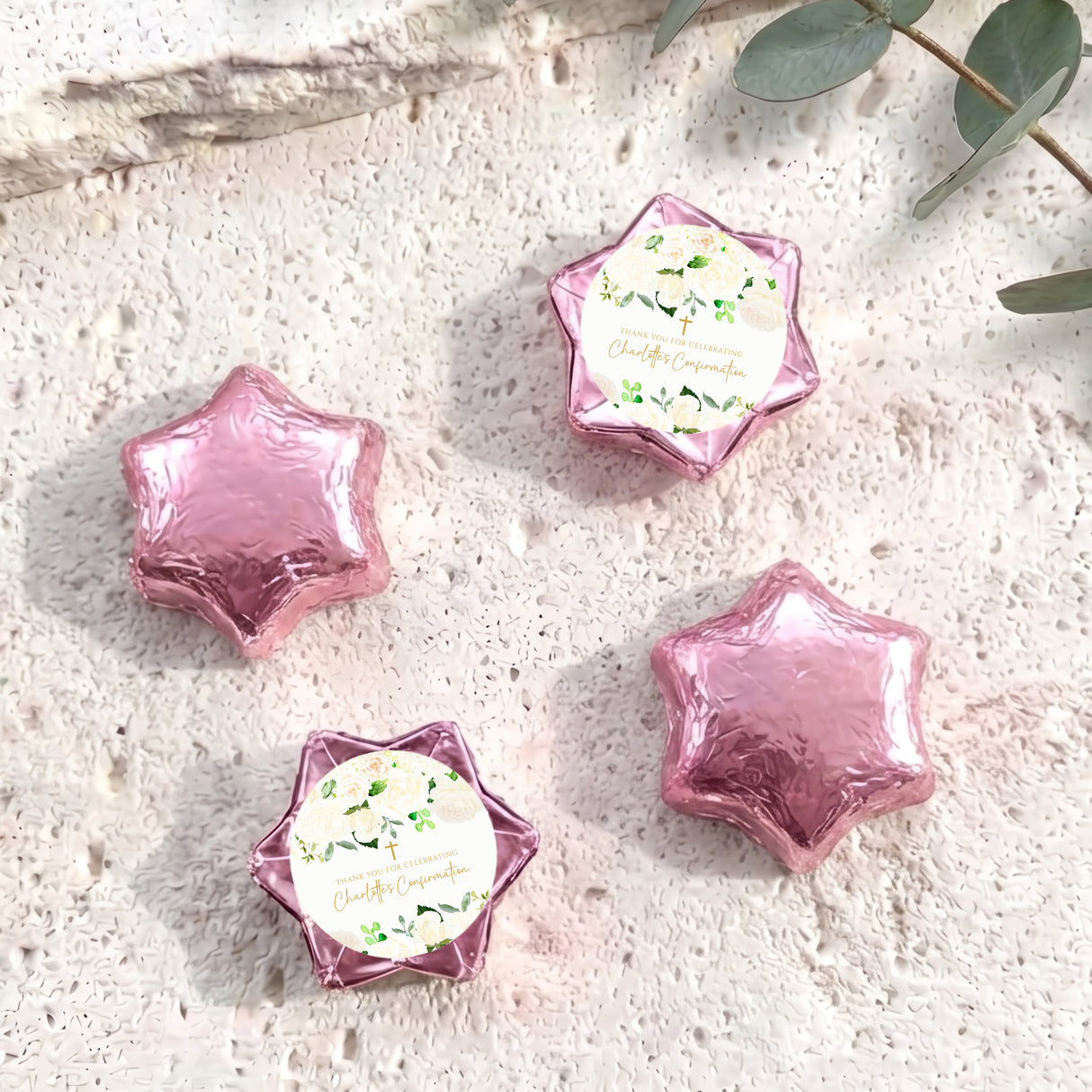Foil-covered chocolate stars in pale pink with floral confirmation label