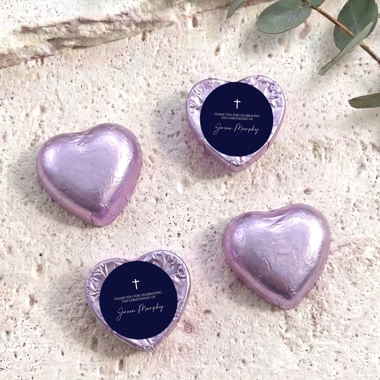 Foil-covered chocolate hearts, lilac metallic with navy label and cross