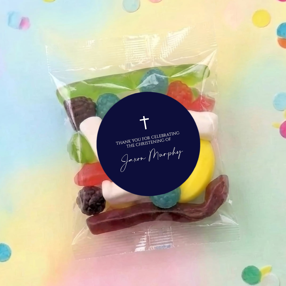 Transparent party mix lolly bag with navy round label, white cross and christening text