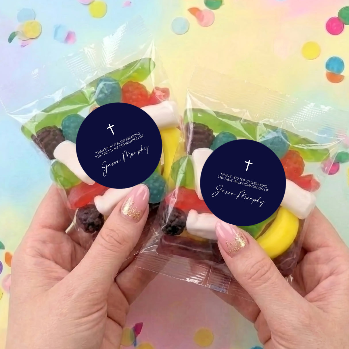Two lolly bags with mixed sweets and navy round cross labels