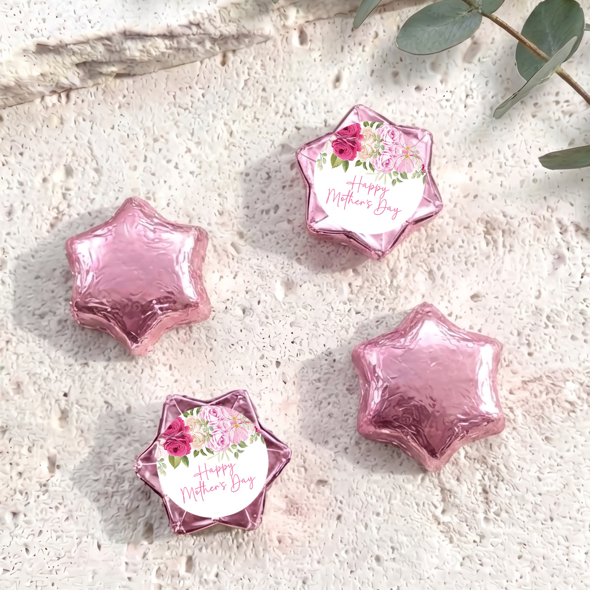 Foil-covered pink chocolate stars, one with floral 'Happy Mother's Day' label