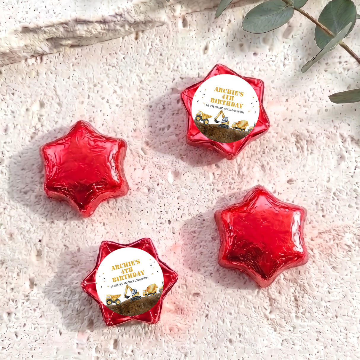 Foil-covered chocolate star sweets in red, with birthday foil label