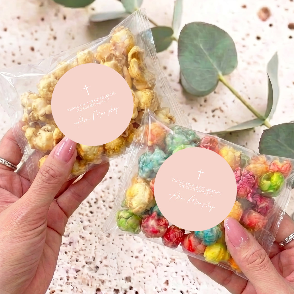 Personalised popcorn bag set with clear bags, pastel kernels, and round blush labels with cross