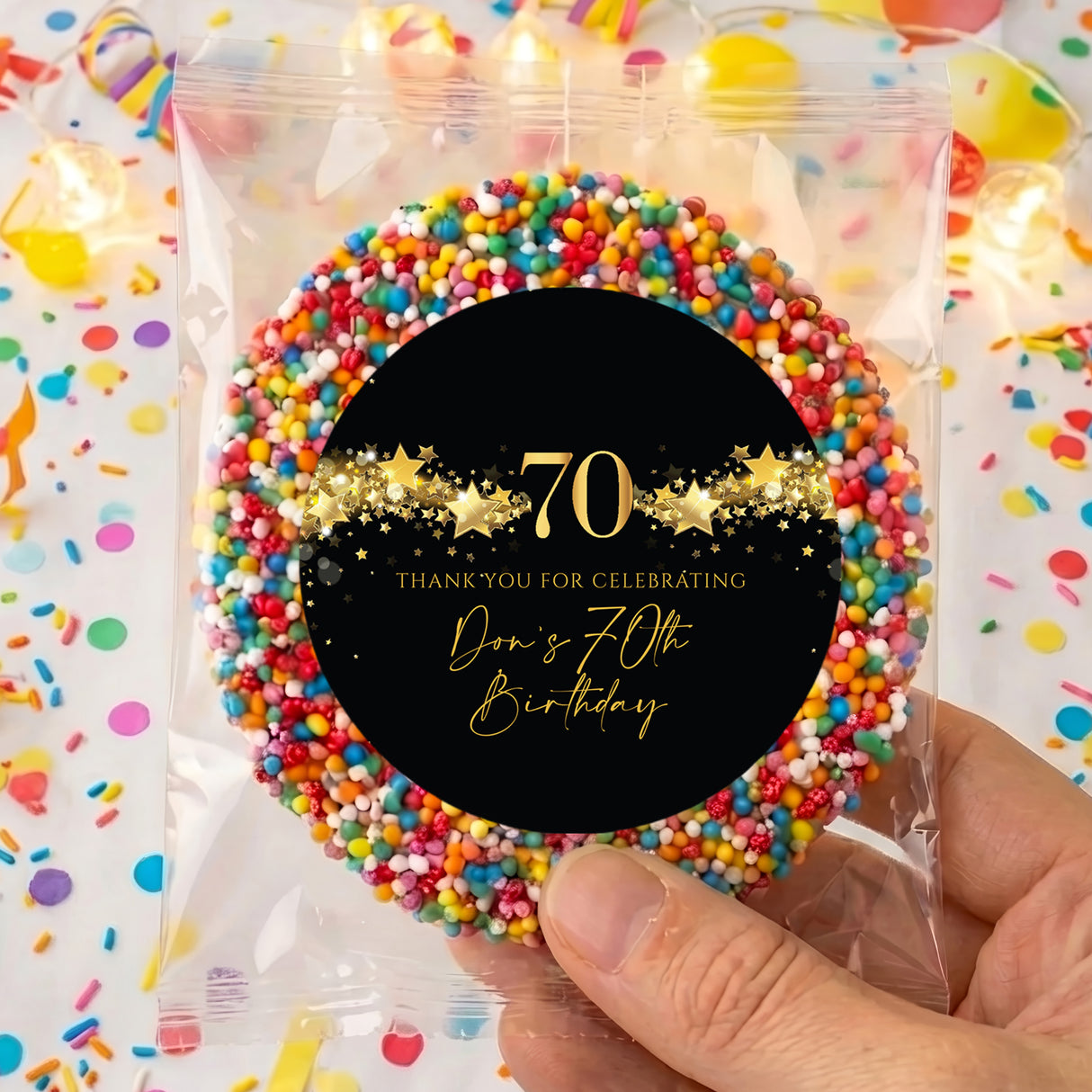 Personalised 70th birthday freckles badge with black circle, gold “70” and stars, colorful sprinkles