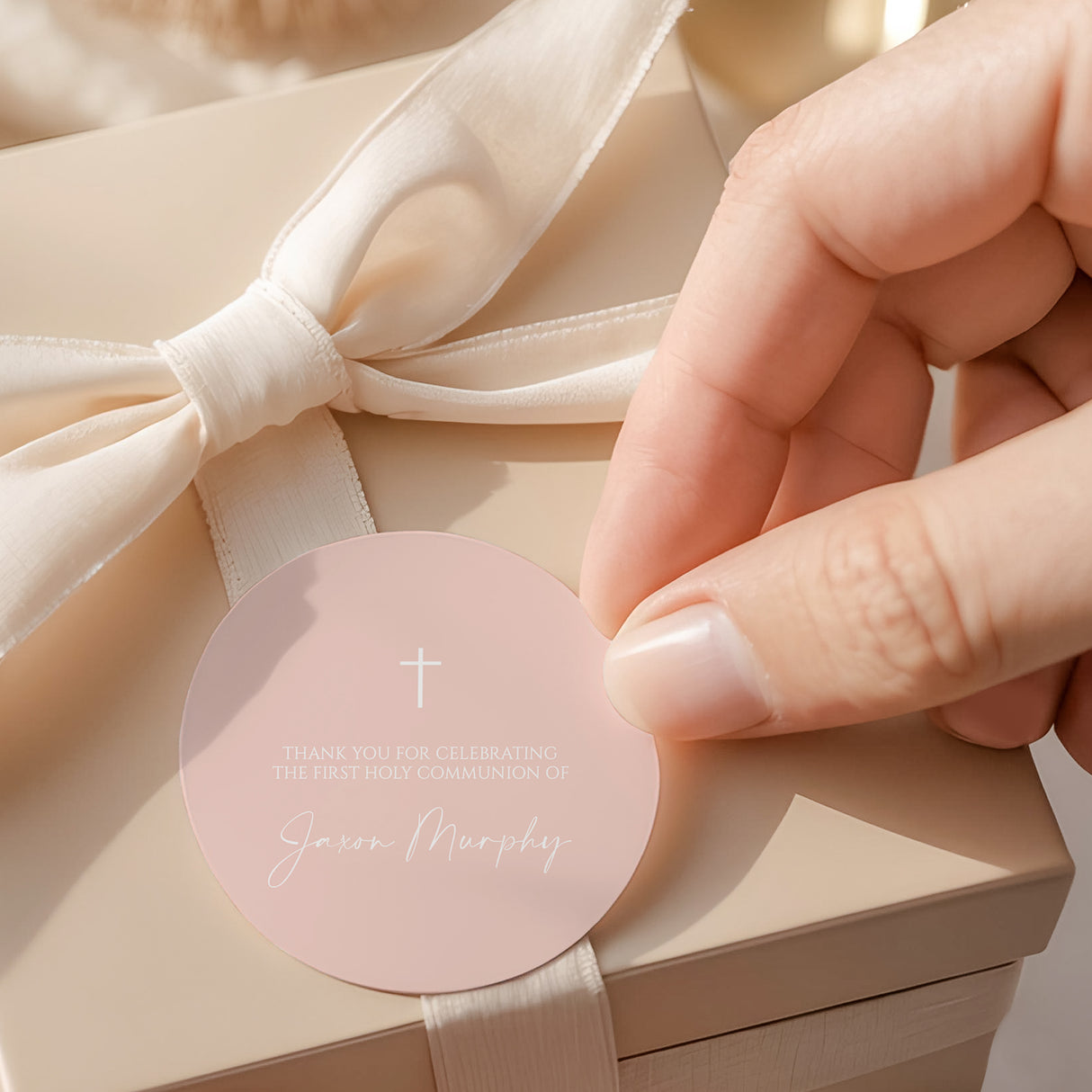Pastel peach round First Communion labels with white cross and printed thank-you text