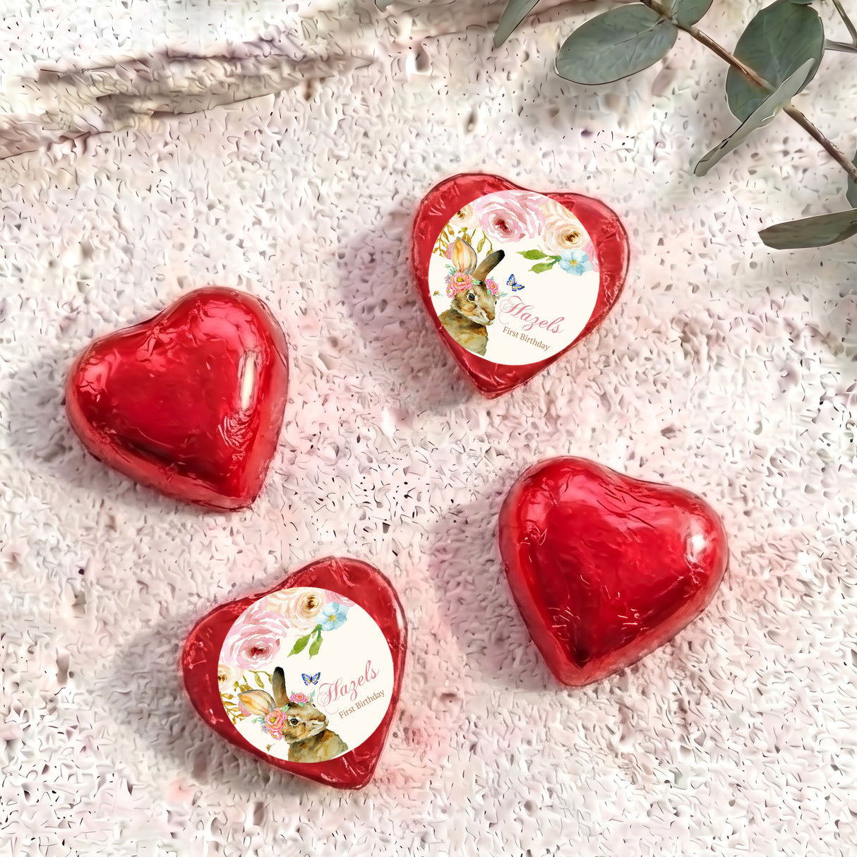 Red foil-covered chocolate hearts with floral wrapped center medallions