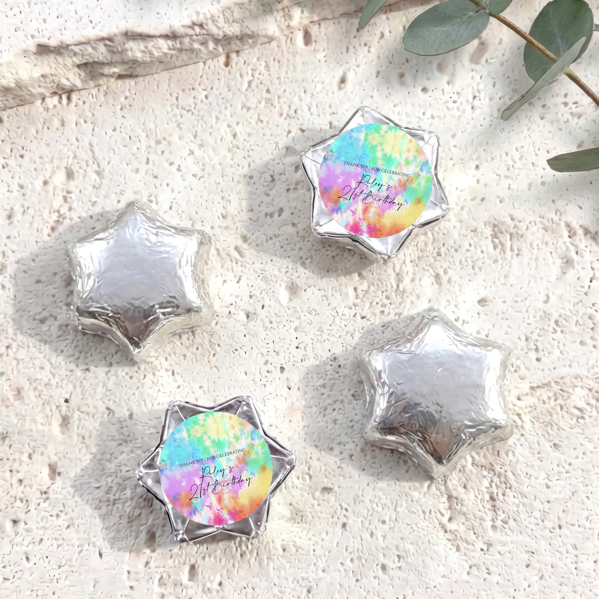 Foil-covered star chocolates in silver with one pastel tie-dye foil star