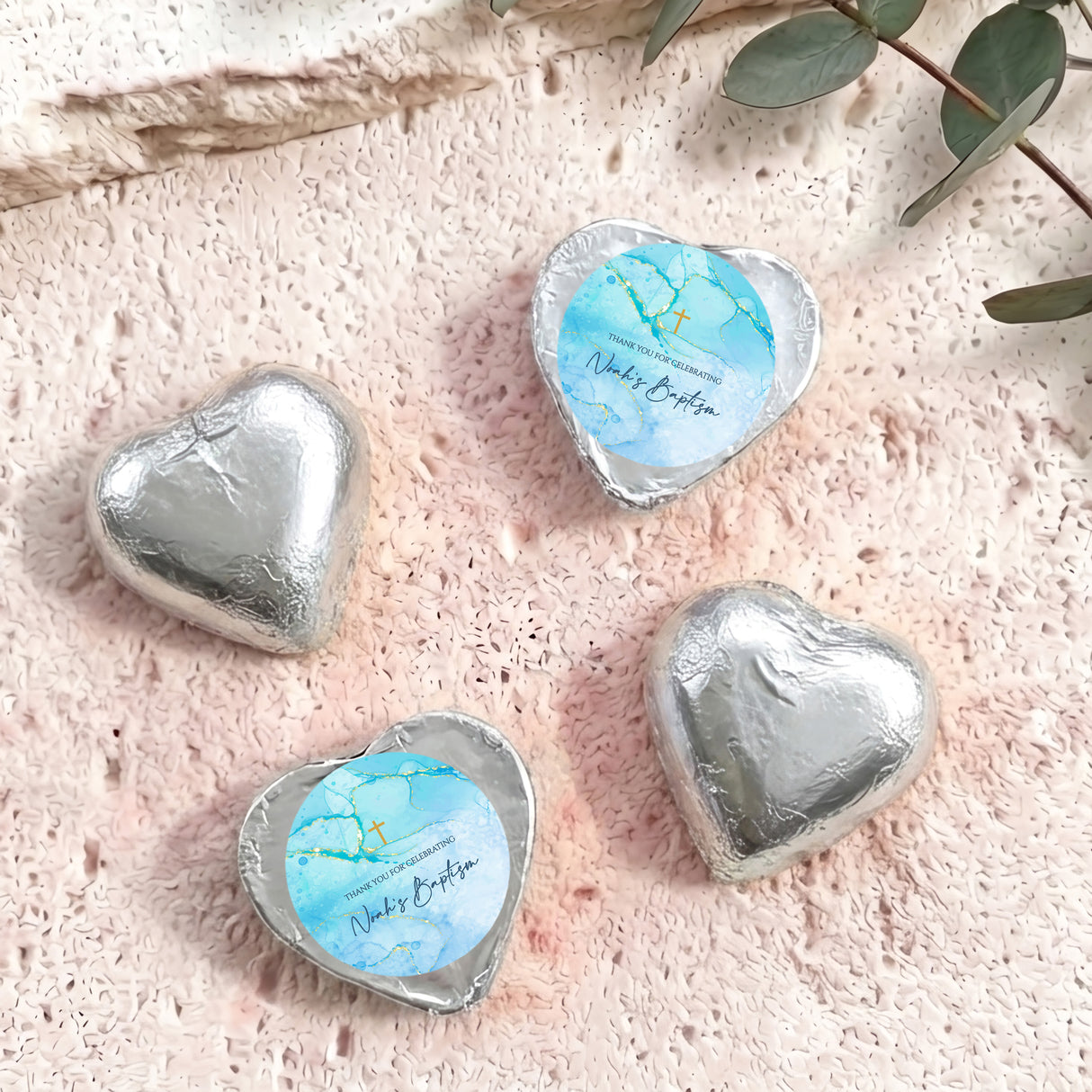 Silver foil heart chocolates for baptism, with light blue label and gold cross print