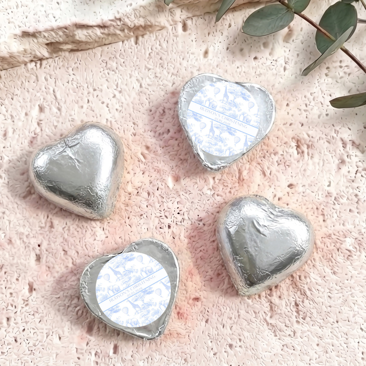 Silver foil-covered chocolate hearts with heart-shaped foil wrap and white label