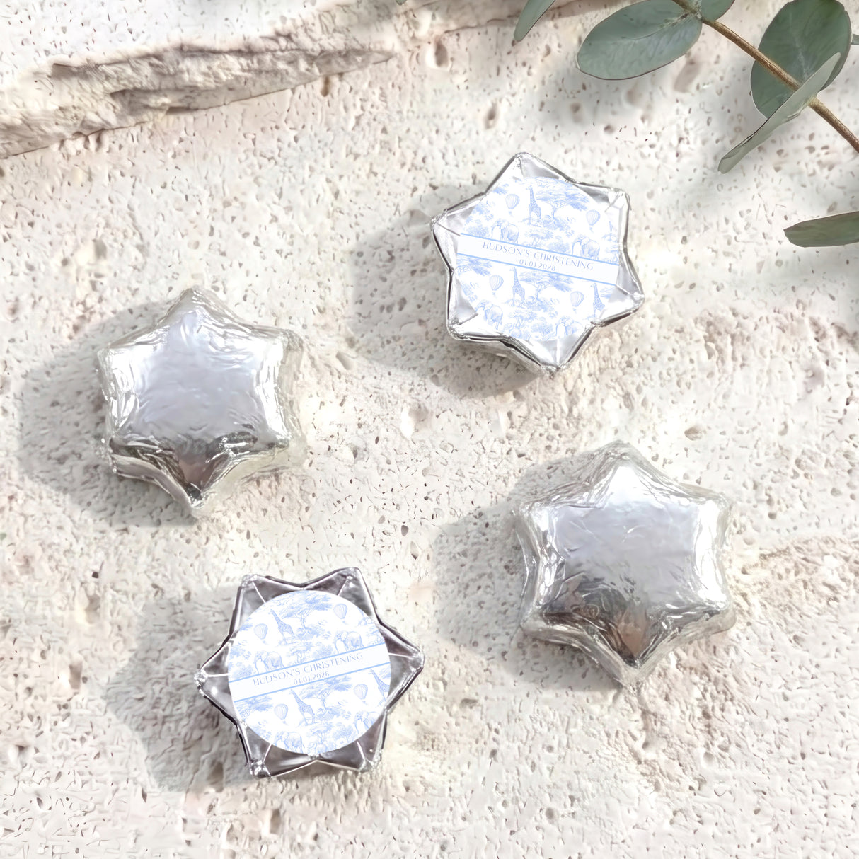 Personalized foil-covered chocolate stars in silver/white, with round label center.