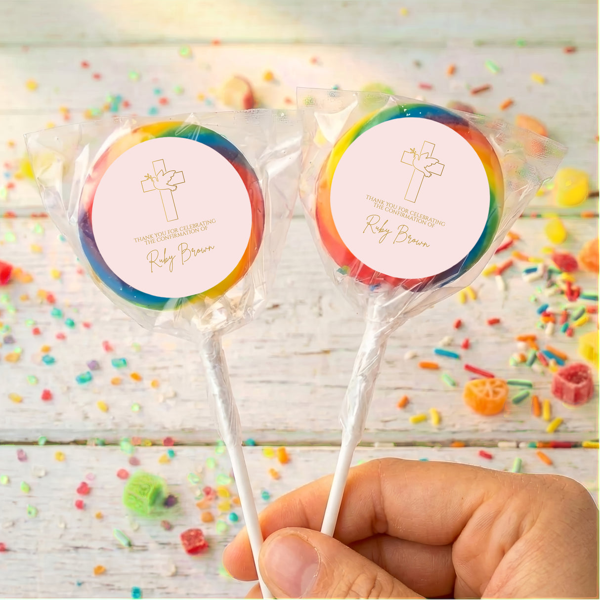 Pink dove cross personalized lollipops with dark-blue-edged wrappers and round printed labels