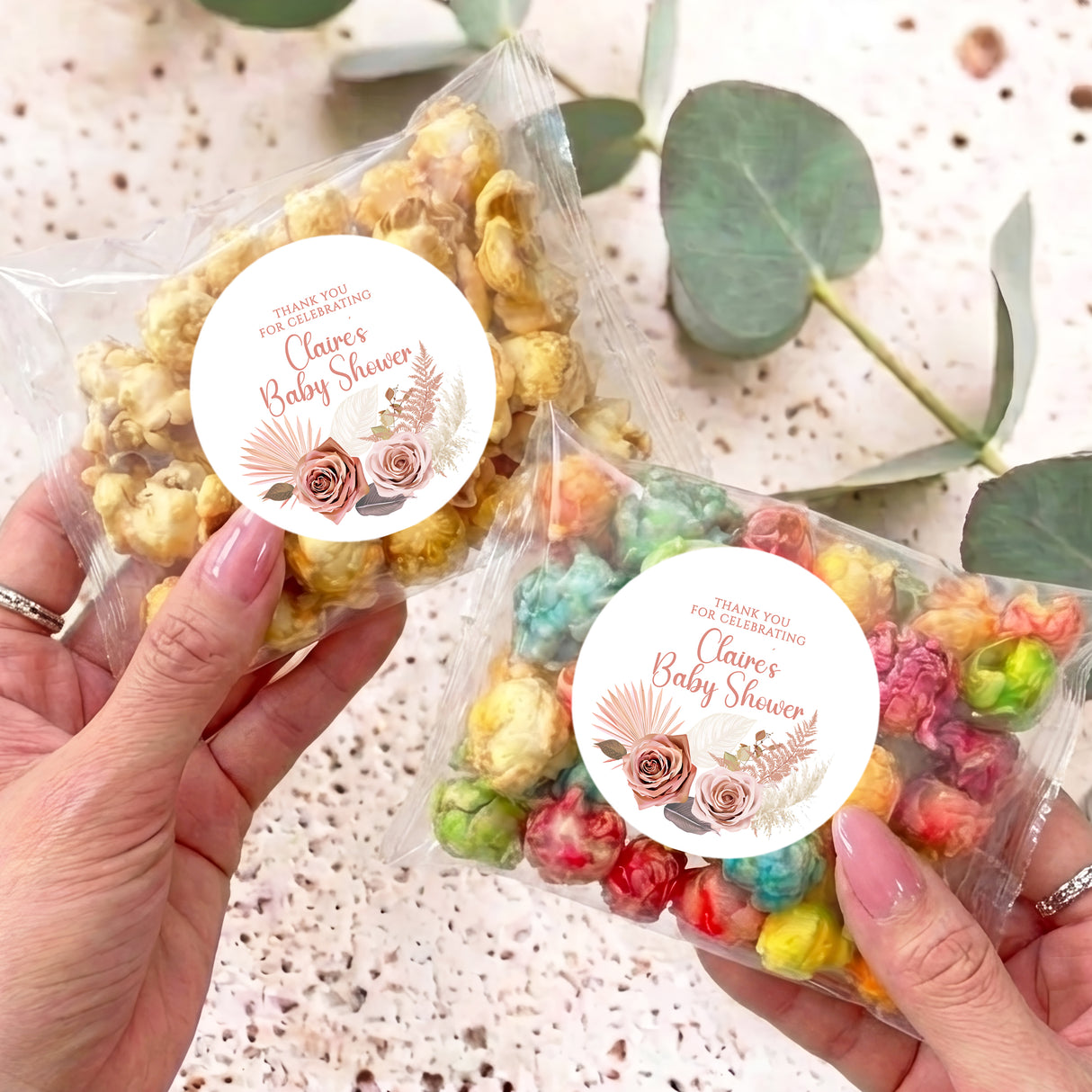 Pink boho baby shower popcorn bag with clear wrap and round floral thank-you label