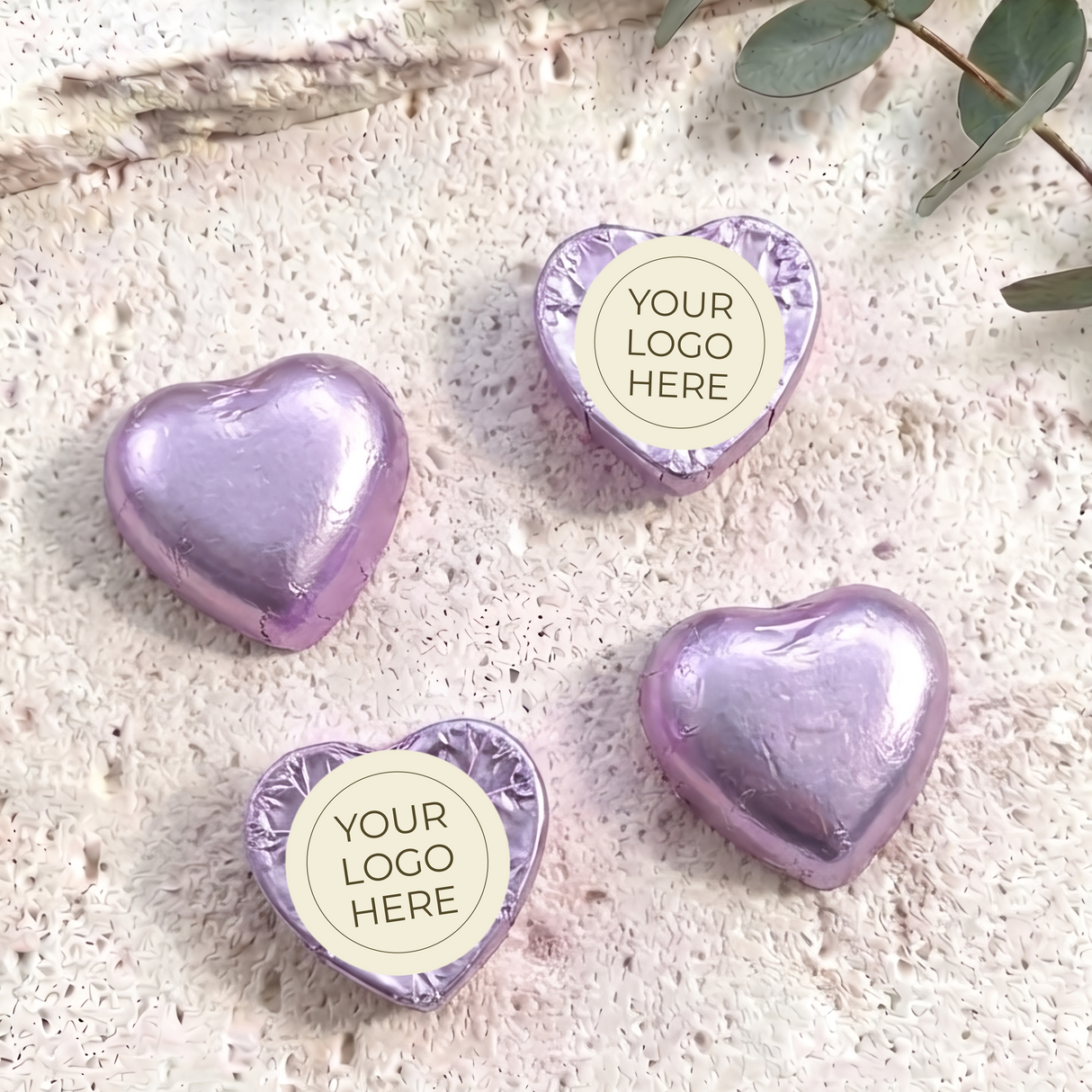 Foil-covered purple chocolate hearts with round personalized logo label