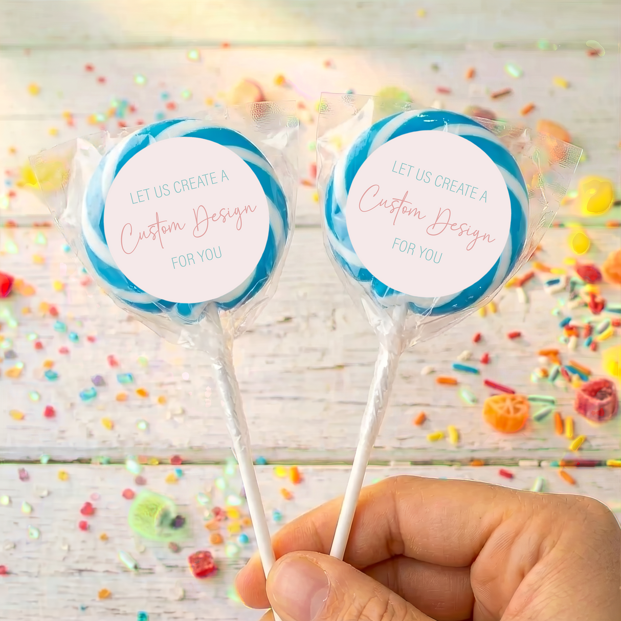 Personalized lollipop pair with blue candy swirl, 'Custom Design' label on each stick