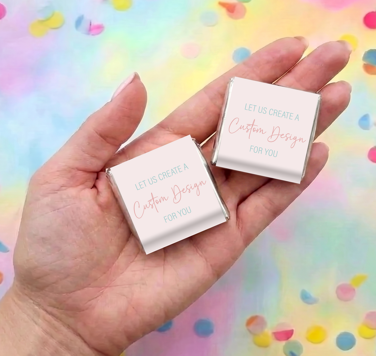 Two mini personalized chocolate squares in hand, gold foil edges with custom text labels