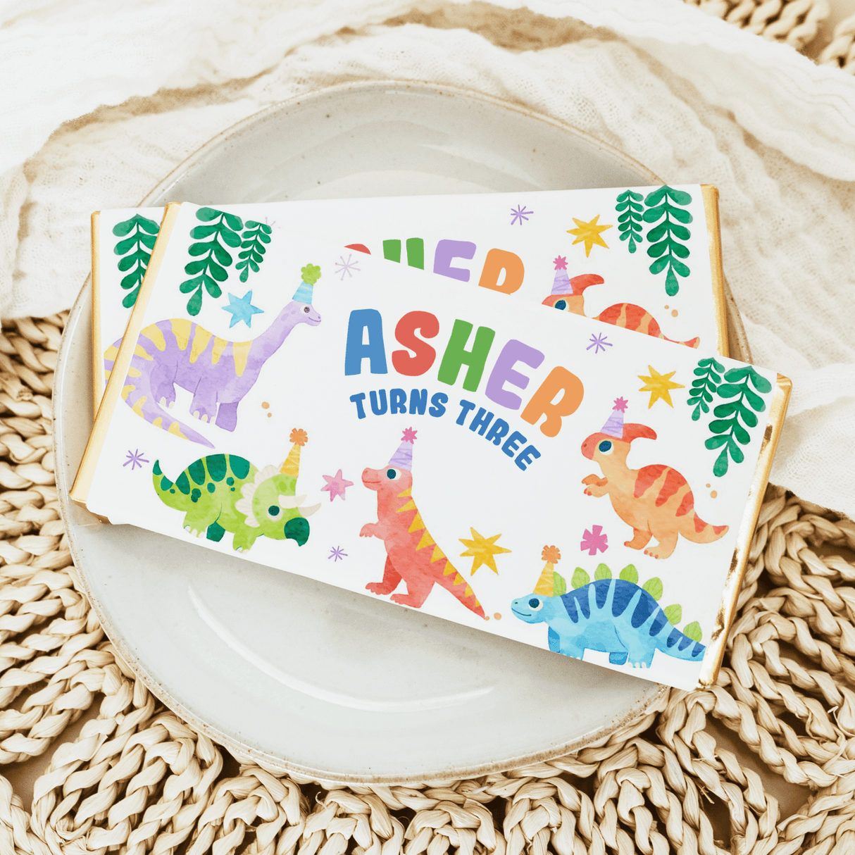 Birthday chocolate bar wrapper with dinosaurs and text “Asher turns three”