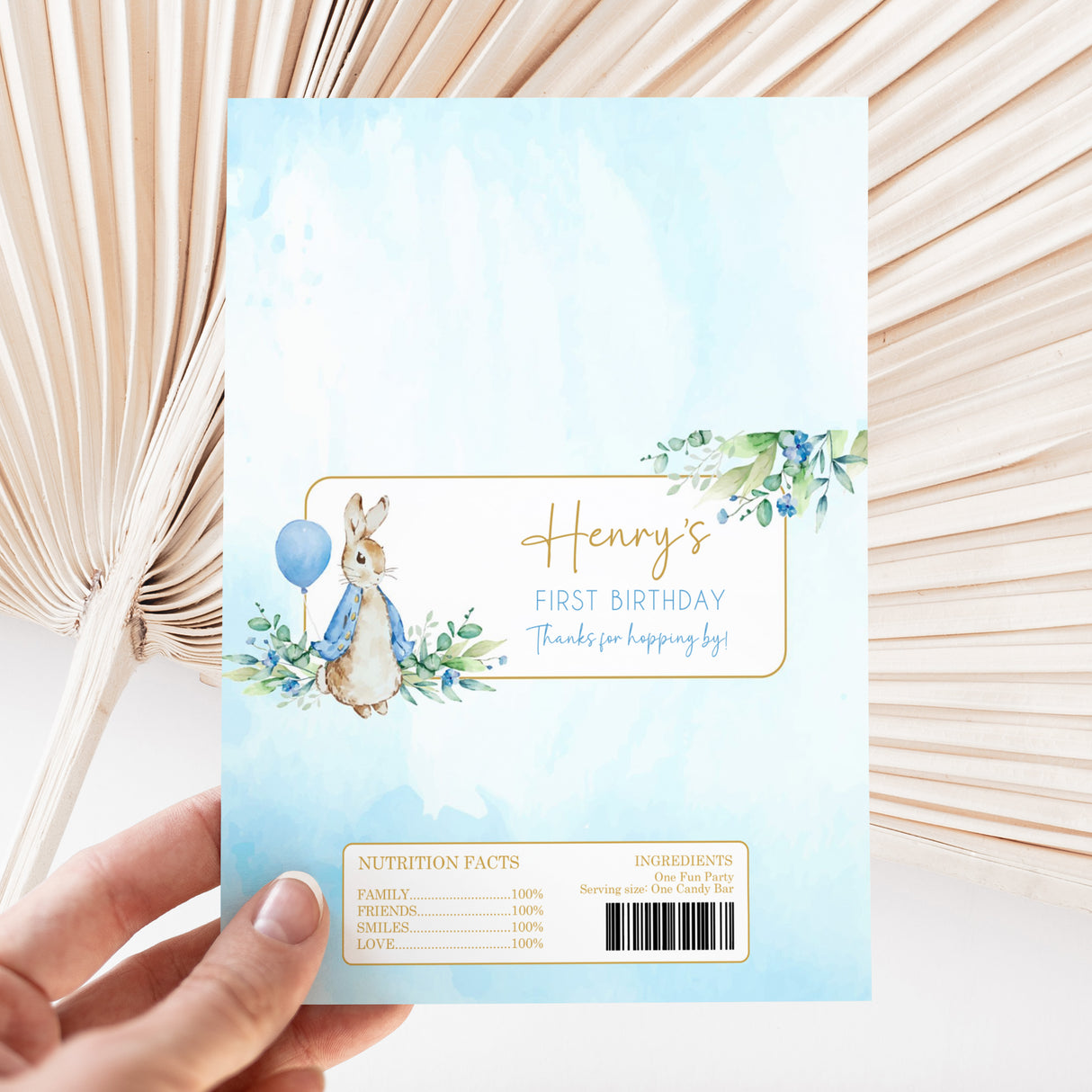 Custom chocolate bar wrapper with blue bunny, balloon, floral frame, and “Henry’s First Birthday” text