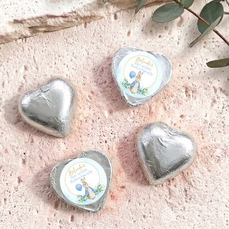 Silver foil-covered chocolate hearts with baby shower label and bunny illustration