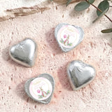 Silver foil-covered chocolate hearts with personalised round label on top.