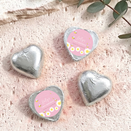 Foil-covered silver chocolate heart chocolates with birthday labels, four foil hearts shown