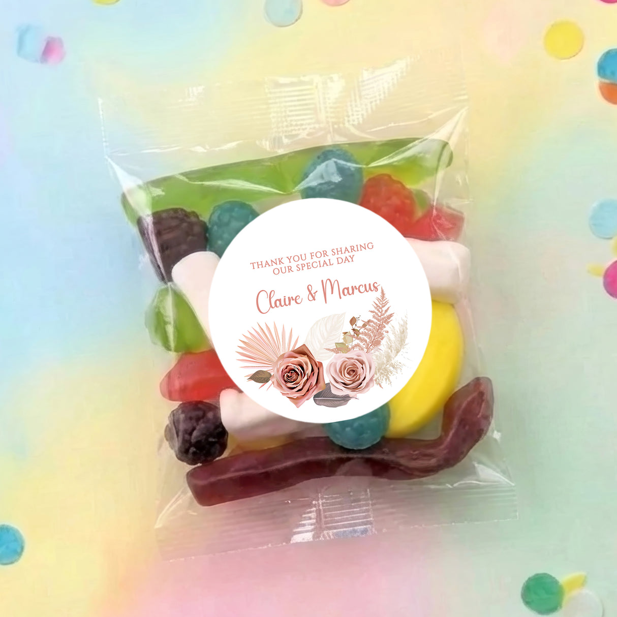 Transparent lolly bag with pink floral circle label, 'Thank you' and names Claire & Marcus