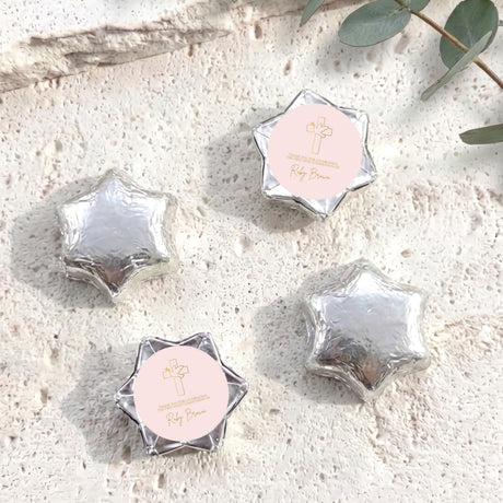 Silver foil chocolate stars with round personalised label and small cross emblem