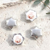 Silver foil-covered chocolate stars with round 'Baby Shower' label