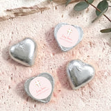 Silver foil heart chocolates with white label, cross and “Lucy Janes” First Holy Communion