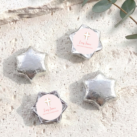Silver foil-covered chocolate star with personalised cross label and name