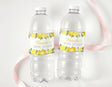 Two clear water bottles with white caps and lemon bridal shower labels for Natasha's