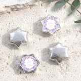Foil-covered chocolate stars set in silver, with one personalized butterfly-style star.