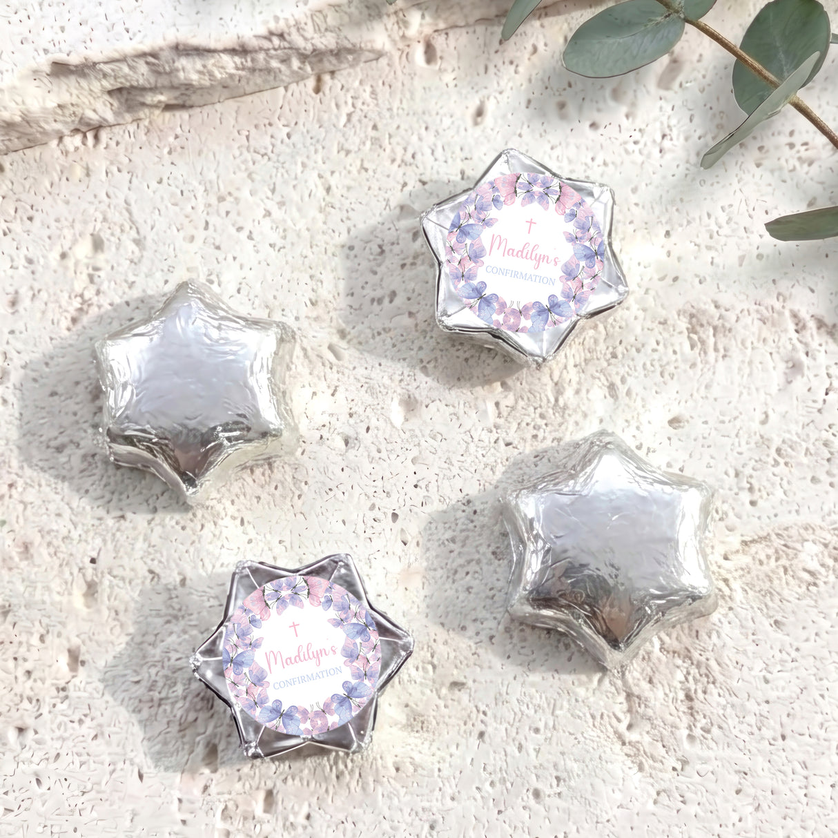Foil-covered chocolate stars in silver with printed pastel border