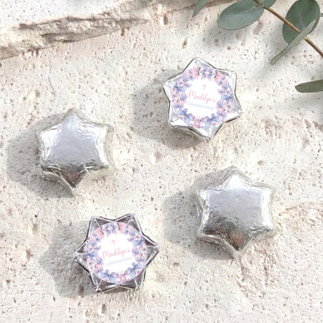 Foil-covered chocolate stars in silver with printed pastel border
