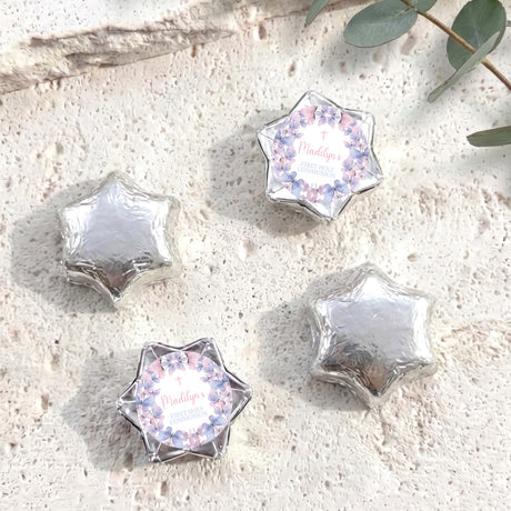 Silver foil-covered chocolate stars with floral First Holy Communion label