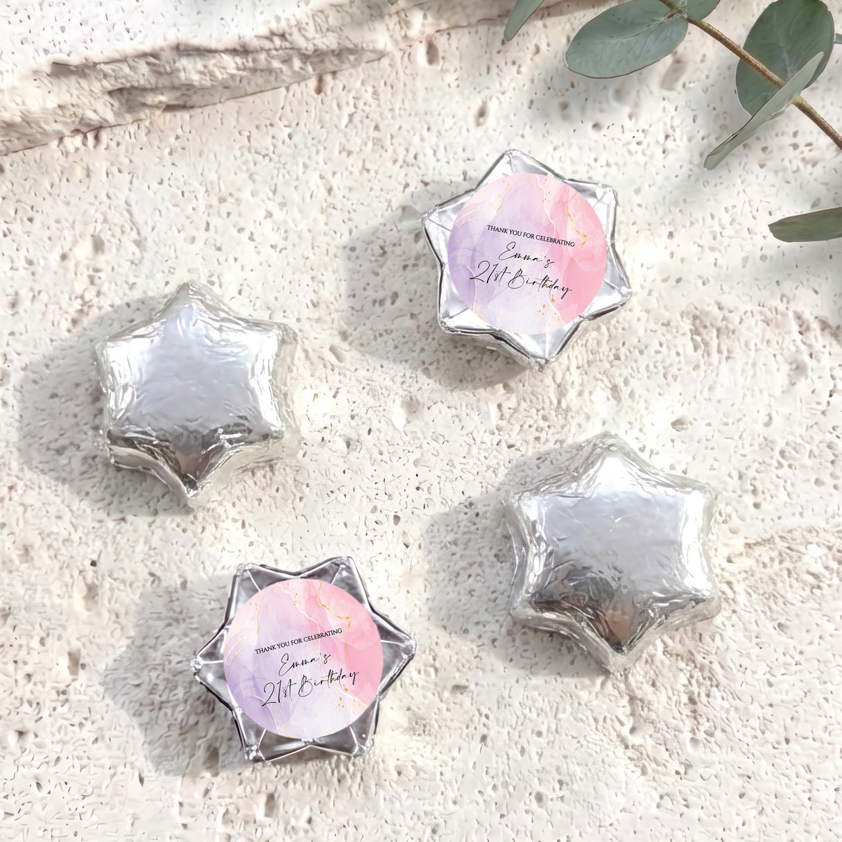 Silver foil-covered chocolate stars with personalized round label