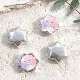 Silver foil-covered chocolate stars with personalized round label