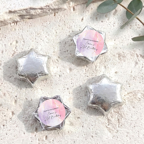 Silver foil-covered chocolate stars with printed personal message on one star