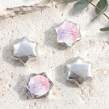 Silver foil star chocolates with circular personalized label in star-shaped wrapper