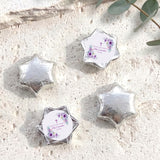 Silver foil-covered chocolate stars with round confirmation label and purple floral cross