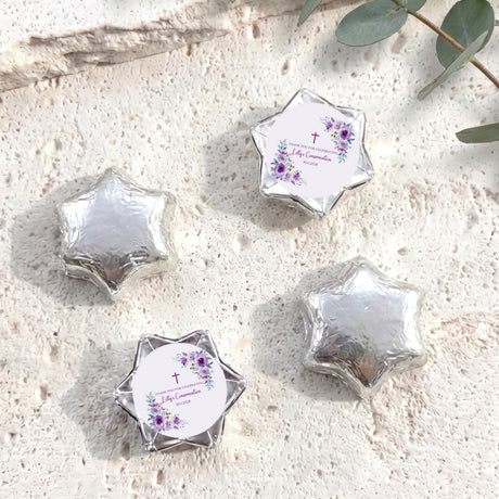 Silver foil-covered chocolate stars with round confirmation label and purple floral cross