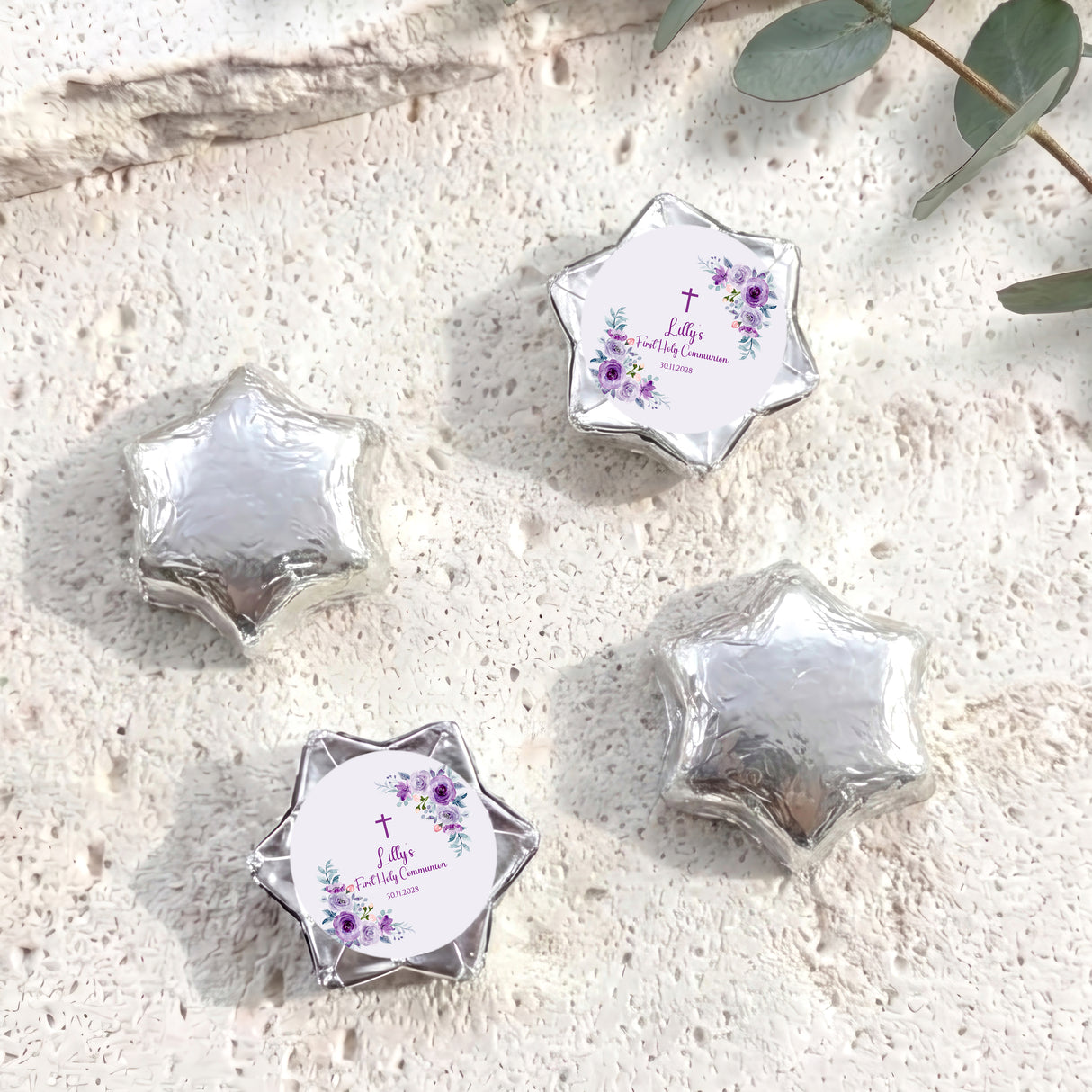 Foil-covered chocolate stars in silver with a First Holy Communion-style label