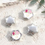 Foil-covered chocolate stars with floral personalized label, silver foil shapes